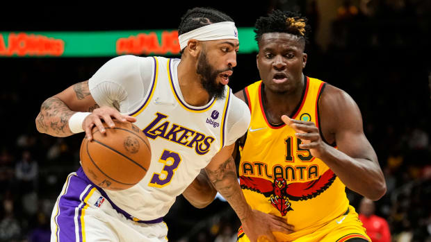 Los Angeles Lakers forward Anthony Davis controls the ball against Atlanta Hawks center Clint Capela. The two teams face off twice in the 2022-23 NBA season.